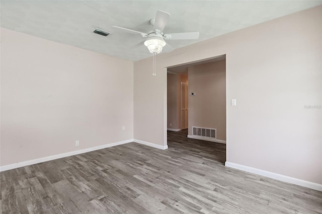 spare room with ceiling fan and light wood-type flooring