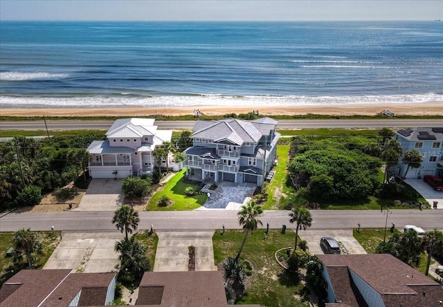 birds eye view of property with a water view and a view of the beach