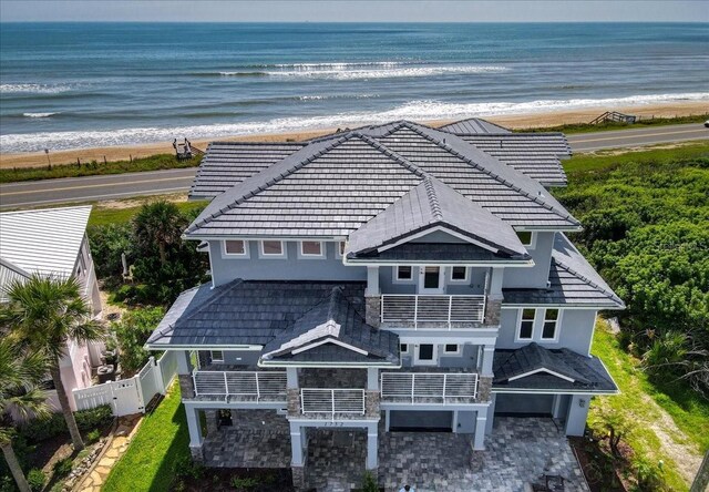 aerial view with a water view and a beach view