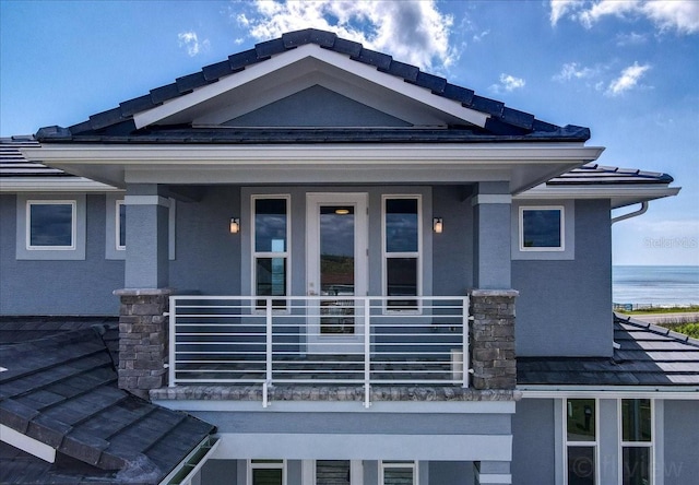 exterior space with a balcony and a water view