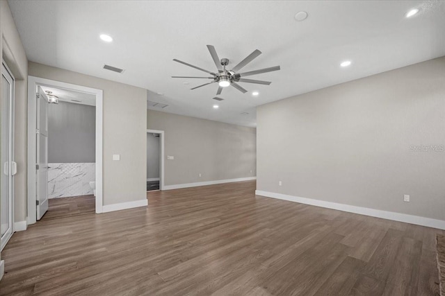 spare room with dark wood-type flooring and ceiling fan