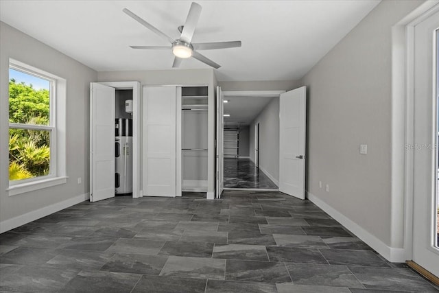 unfurnished bedroom featuring ceiling fan and electric water heater