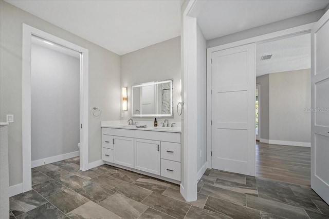 bathroom featuring vanity and toilet