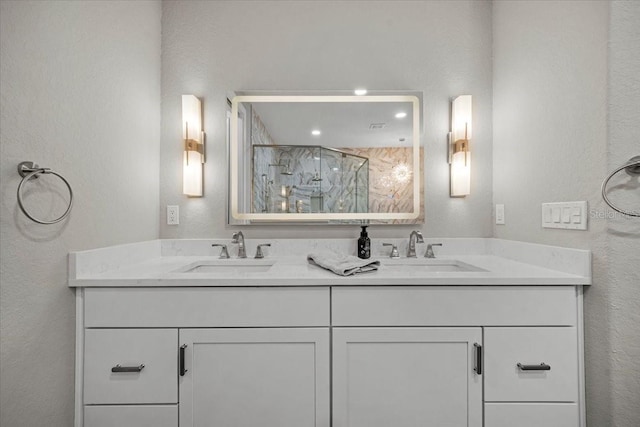 bathroom with vanity and a shower with shower door