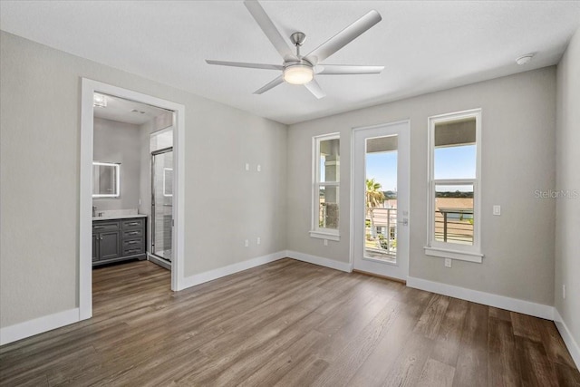 unfurnished room featuring ceiling fan and dark hardwood / wood-style flooring