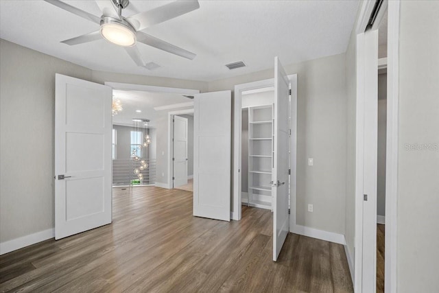 unfurnished bedroom with wood-type flooring and ceiling fan