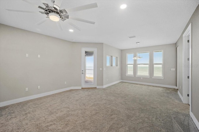 interior space featuring light colored carpet and ceiling fan