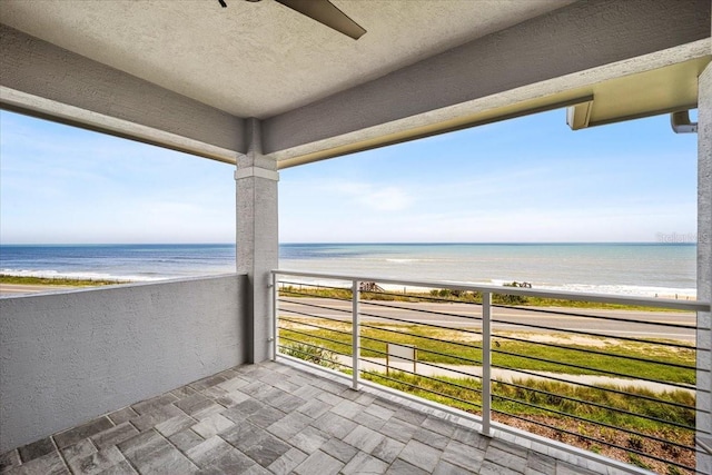 balcony featuring a water view and a view of the beach