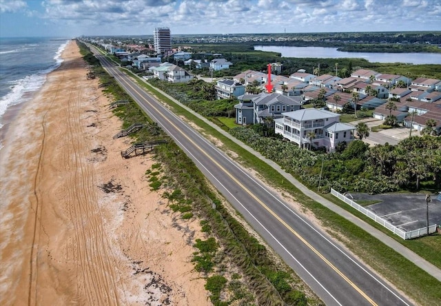 bird's eye view featuring a water view and a view of the beach