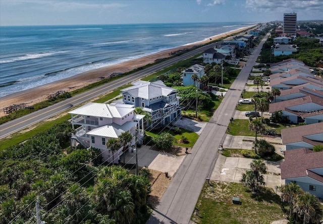 aerial view with a water view and a view of the beach