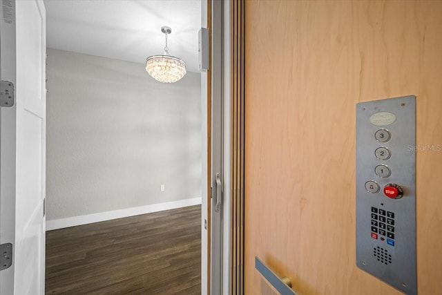 interior details with hardwood / wood-style flooring and a chandelier