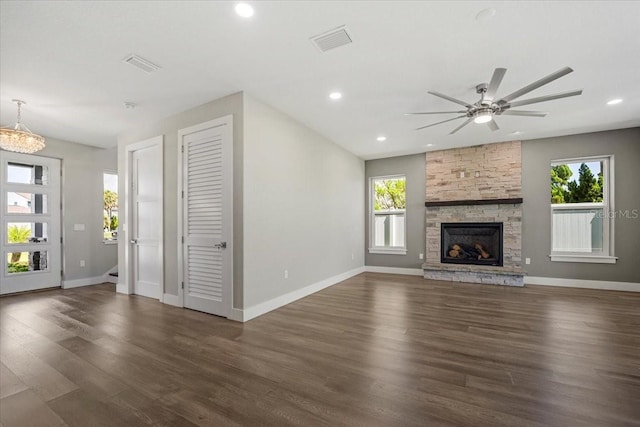 unfurnished living room with dark hardwood / wood-style floors, ceiling fan, and a fireplace