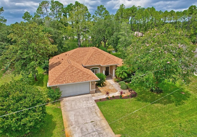 mediterranean / spanish-style house with a garage and a front yard