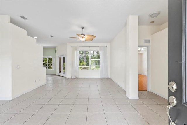 empty room featuring ceiling fan and light tile patterned floors