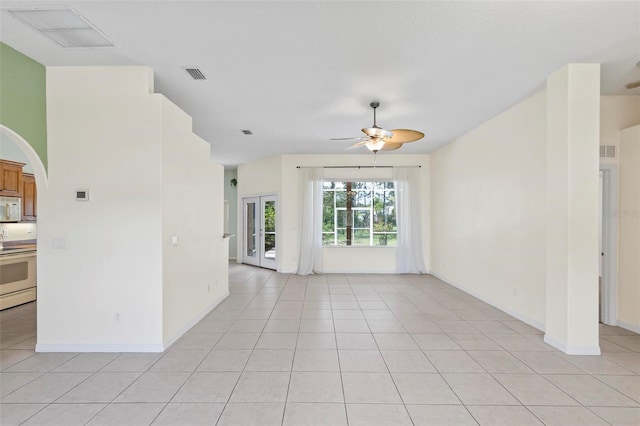 spare room featuring ceiling fan and light tile patterned floors