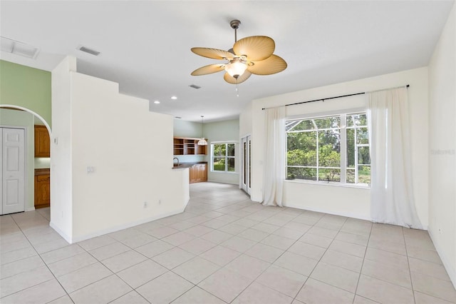 spare room featuring light tile patterned flooring and ceiling fan