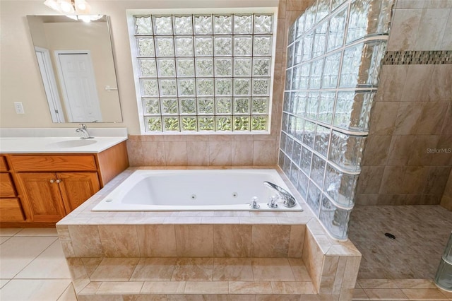 bathroom with tile patterned flooring, separate shower and tub, and vanity