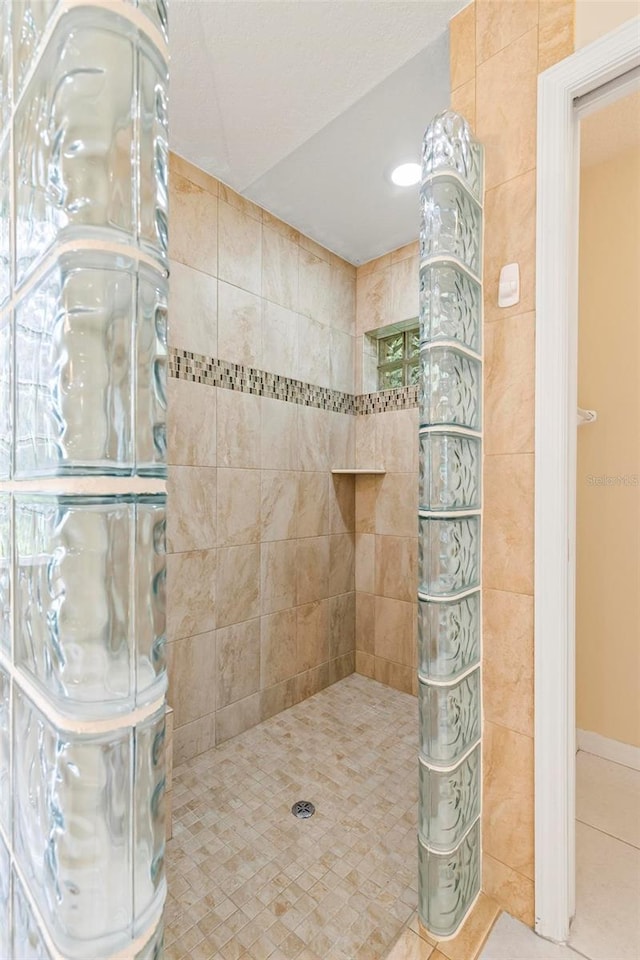 bathroom featuring tiled shower and tile patterned floors