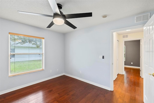 empty room featuring hardwood / wood-style flooring and ceiling fan