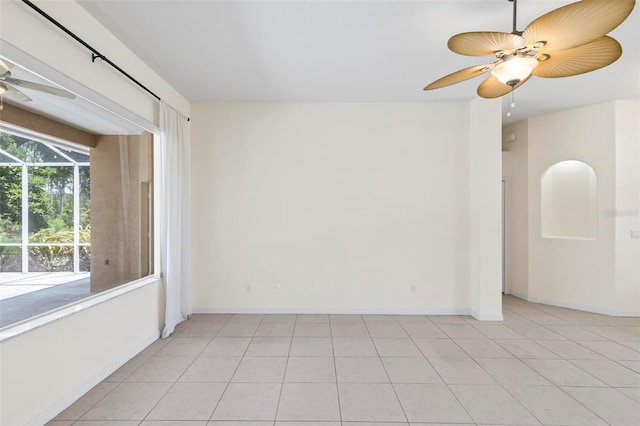 spare room featuring ceiling fan and light tile patterned floors