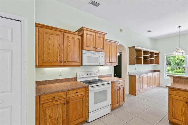 kitchen featuring decorative light fixtures, white appliances, light tile patterned floors, and a textured ceiling