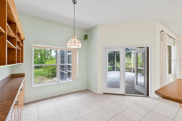 unfurnished dining area with light tile patterned floors