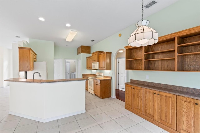 kitchen featuring hanging light fixtures, light tile patterned flooring, kitchen peninsula, and white appliances