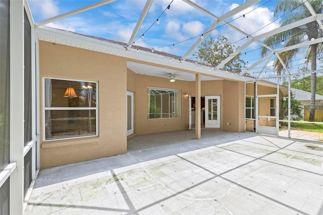 unfurnished sunroom featuring ceiling fan