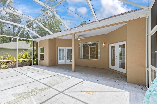 unfurnished sunroom featuring french doors and ceiling fan