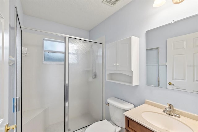 bathroom with vanity, an enclosed shower, a textured ceiling, and toilet