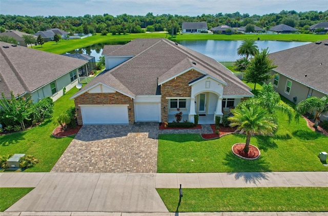 view of front of house featuring a water view and a front lawn