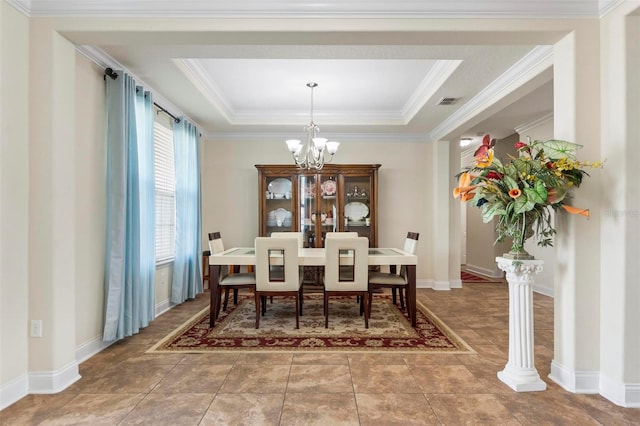 dining area with tile patterned floors, crown molding, a tray ceiling, and a notable chandelier