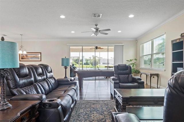 living room featuring ornamental molding, tile patterned floors, a textured ceiling, and ceiling fan