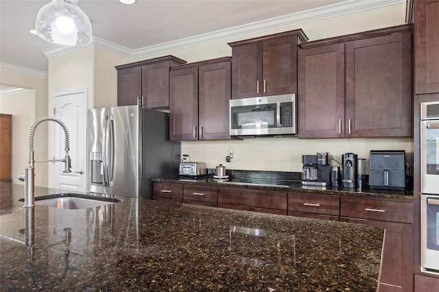 kitchen featuring dark stone counters, crown molding, sink, dark brown cabinetry, and appliances with stainless steel finishes