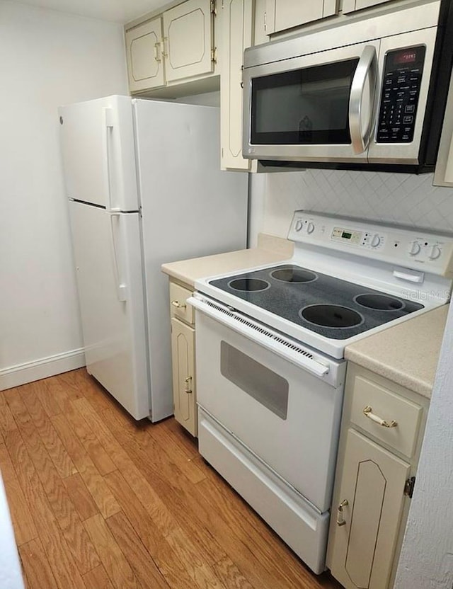 kitchen featuring white appliances and light hardwood / wood-style flooring