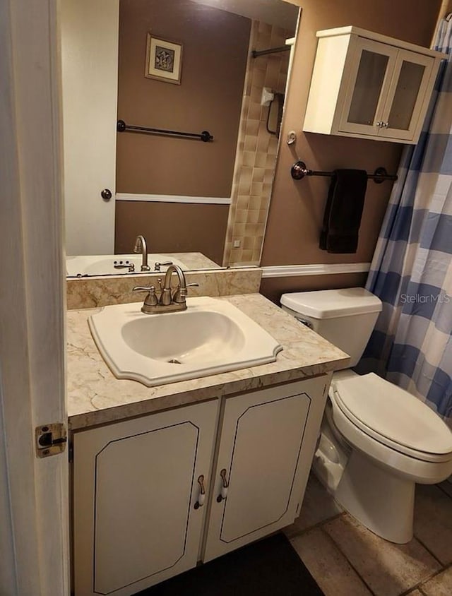 bathroom featuring toilet and vanity