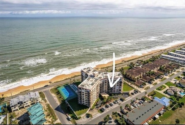 bird's eye view with a water view and a beach view