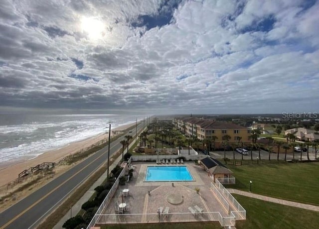 exterior space with a water view and a view of the beach