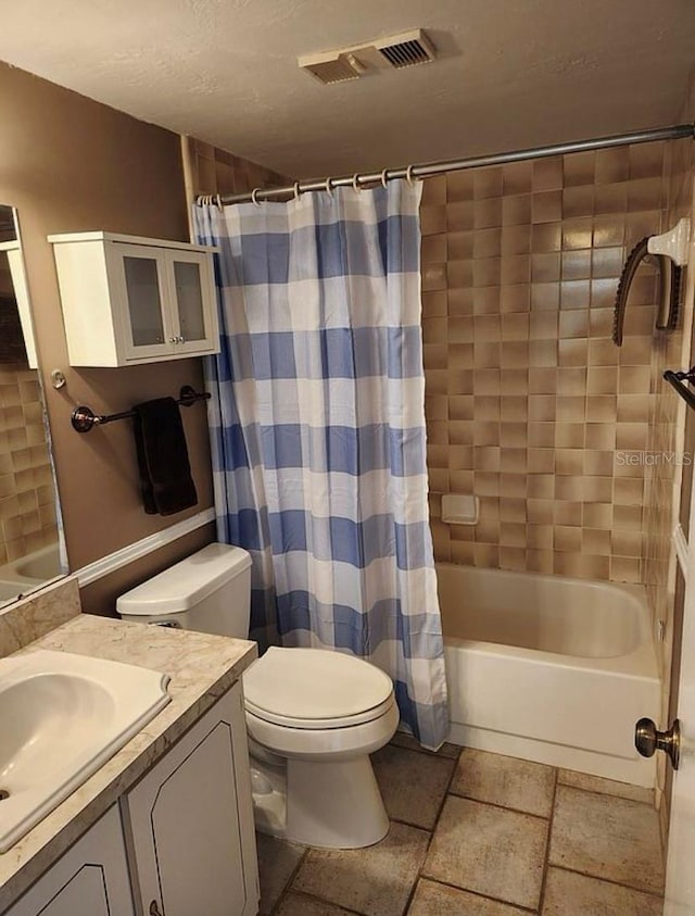 full bathroom featuring toilet, vanity, and shower / tub combo with curtain