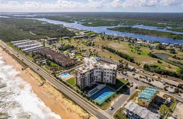 drone / aerial view with a water view and a view of the beach