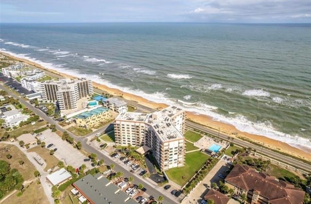 birds eye view of property featuring a view of the beach and a water view