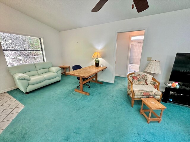 living room featuring carpet, ceiling fan, and vaulted ceiling