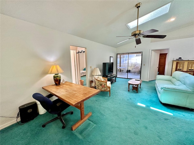 carpeted office space featuring ceiling fan and vaulted ceiling with skylight