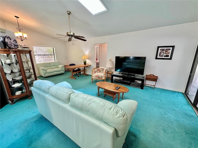 carpeted living room with lofted ceiling and ceiling fan with notable chandelier