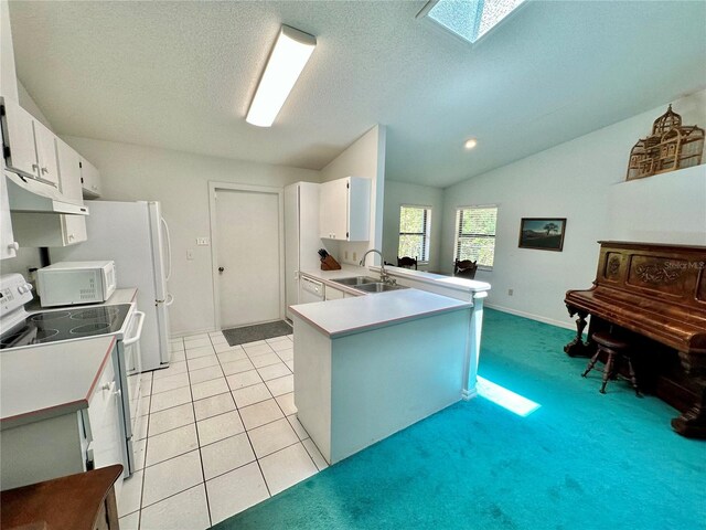 kitchen with white cabinetry, white appliances, light tile patterned floors, kitchen peninsula, and sink