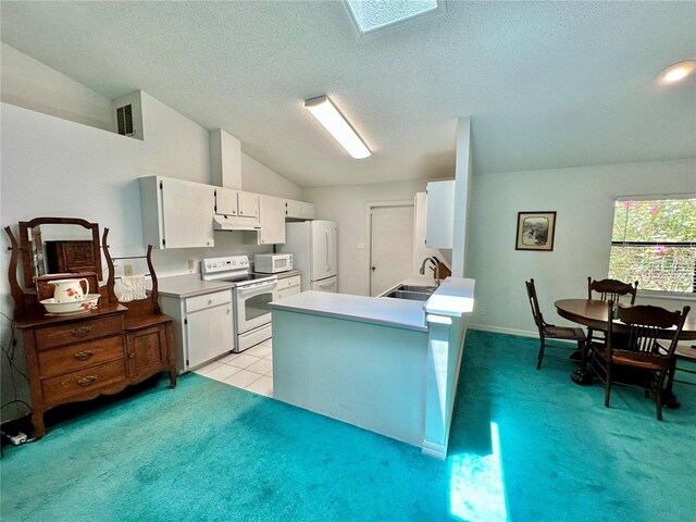 kitchen featuring white appliances, kitchen peninsula, light colored carpet, vaulted ceiling, and sink