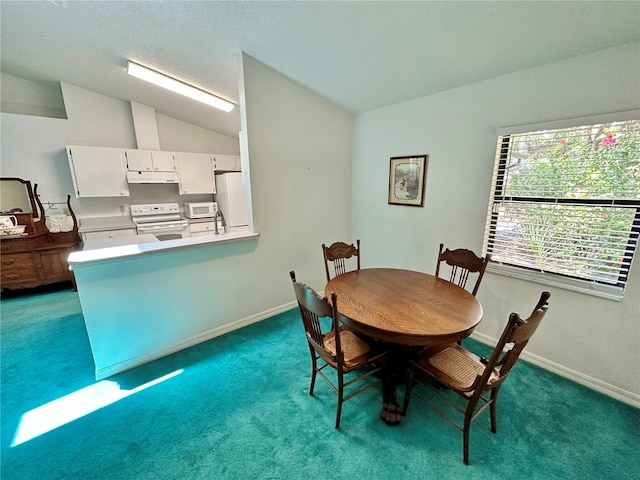 dining room with dark colored carpet and lofted ceiling