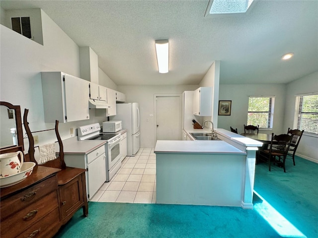 kitchen featuring light carpet, kitchen peninsula, sink, and white appliances