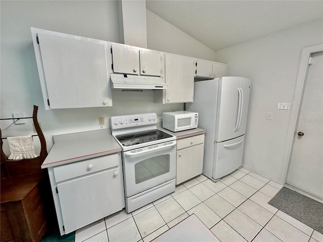 kitchen featuring light tile patterned flooring, lofted ceiling, and white appliances