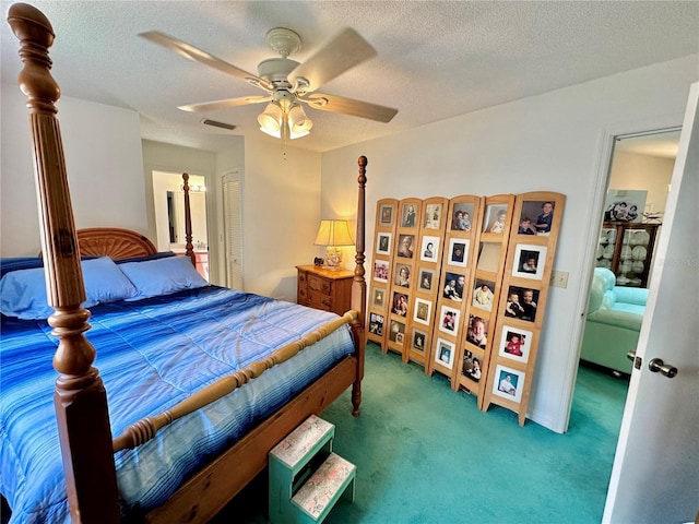 carpeted bedroom featuring a textured ceiling and ceiling fan